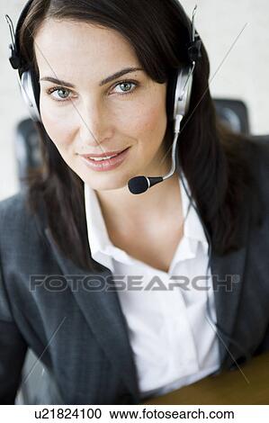 Woman with headset looking into camera View Large Photo Image Stock Image - Woman with headset looking into camera. Fotosearch