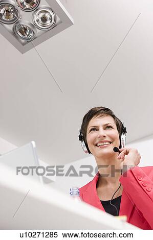 Woman with headset working View Large Photo Image Stock Photography - Woman with headset working. Fotosearch