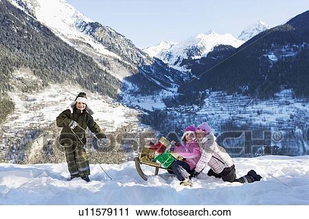 Children playing in snow with presents View Large Photo Image Stock Image - Children playing in snow with presents. Fotosearch