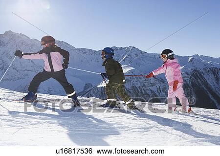 Children walking up slope with skis on View Large Photo Image Stock Photograph - Children walking up slope with skis on. Fotosearch