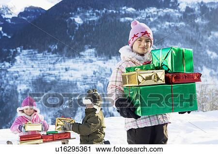 Children with presents in the snow View Large Photo Image Stock Image - Children with presents in the snow. Fotosearch