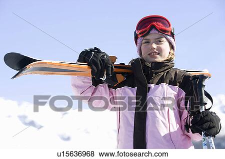 Girl with skis on her shoulder View Large Photo Image Stock Photo - Girl with skis on her shoulder. Fotosearch