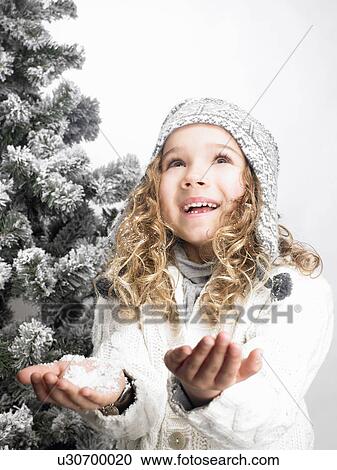 Little girl next to a fir-tree View Large Photo Image Stock Image - Little girl next to a fir-tree. Fotosearch