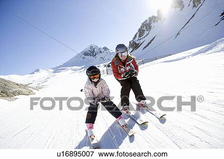 Stock Photo - Mother and daughter skiing. Fotosearch