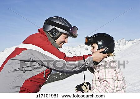 Mother holding daughters helmet View Large Photo Image Stock Image - Mother holding daughters helmet. Fotosearch