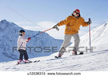 Mother pulling child on skis View Large Photo Image Stock Photography - Mother pulling child on skis. Fotosearch