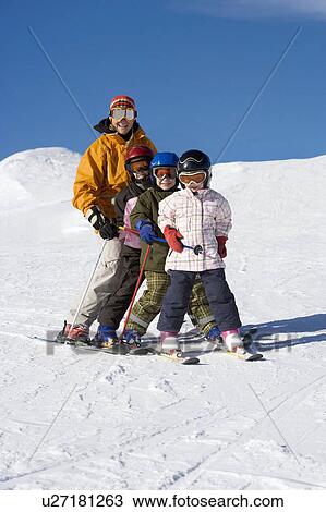 Mother skiing with children View Large Photo Image Stock Image - Mother skiing with children. Fotosearch