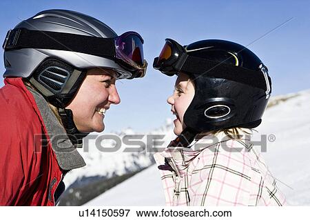 Stock Photo - Mother smiling at daughter. Fotosearch