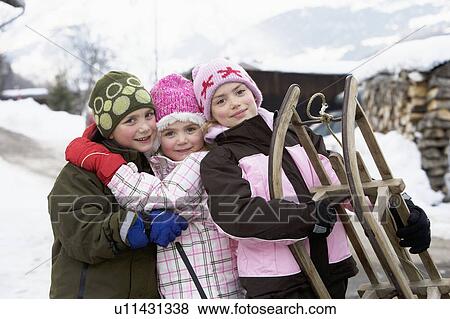 Portrait of children with sledge View Large Photo Image Stock Photo - Portrait of children with sledge. Fotosearch