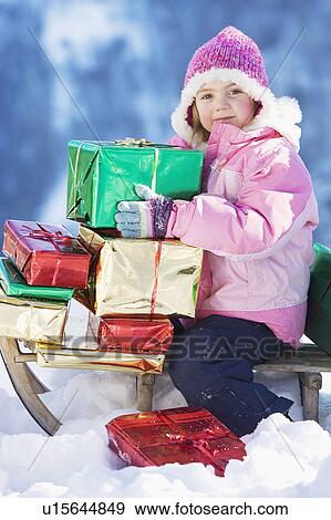 Portrait of girl on sledge with presents View Large Photo Image Stock Photo - Portrait of girl on sledge with presents. Fotosearch