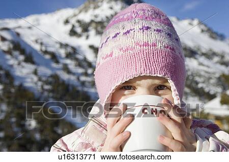 Stock Image - Portrait of girl with drink in mountains. Fotosearch