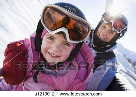 Young girl and grandmother on chair lift View Large Photo Image Stock Image - Young girl and grandmother on chair lift. Fotosearch