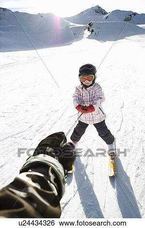 Stock Photograph - Young girl being towed on skis. Fotosearch