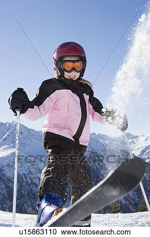 Young girl flicking snow off her skis View Large Photo Image Stock Image - Young girl flicking snow off her skis. Fotosearch