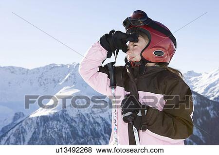 Young girl in ski kit looking at scenery View Large Photo Image Stock Photo - Young girl in ski kit looking at scenery. Fotosearch