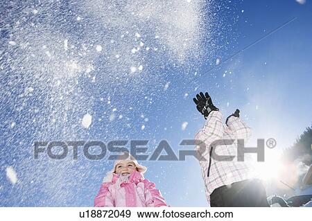 Young girls throwing snow in the air View Large Photo Image Stock Photo - Young girls throwing snow in the air. Fotosearch