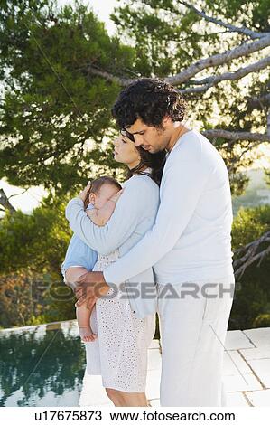 Family w/ baby embracing in nature. View Large Photo Image Stock Image - Family w/ baby embracing in nature.. Fotosearch