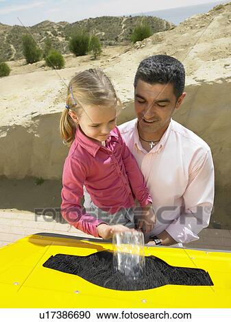 Father helping young daughter (5-7) place plastic bottle in recycling bin, Alicante, Spain, View Large Photo Image Stock Image - Father helping young daughter (5-7) place plastic bottle in recycling bin, Alicante, Spain,. Fotosearch