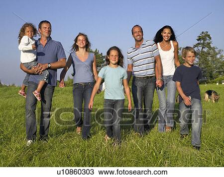 Stock Image - Group of people and children walking.. Fotosearch
