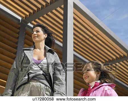 Low angle view of mother and daughter (5-7) with wind blowing their hair, Alicante, Spain, View Large Photo Image Stock Photo - Low angle view of mother and daughter (5-7) with wind blowing their hair, Alicante, Spain,. Fotosearch