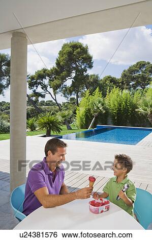 Man and boy eating ice cream. View Large Photo Image Stock Photograph - Man and boy eating ice cream.. Fotosearch