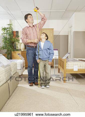 Man and boy measuring each others height. View Large Photo Image Stock Image - Man and boy measuring each others height.. Fotosearch