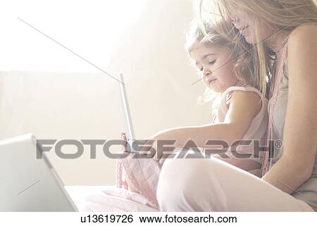 Mother and daughter (2-4) using laptop. View Large Photo Image Stock Photograph - Mother and daughter (2-4) using laptop.. Fotosearch