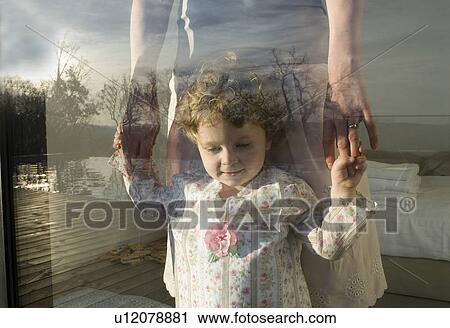 Mother and daughter (9-12 months) looking through window. View Large Photo Image Stock Image - Mother and daughter (9-12 months) looking through window.. Fotosearch