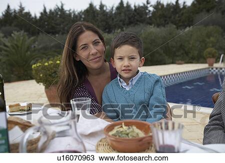 Mother and son (4-6) at the table, outdoors, portrait View Large Photo Image Stock Image - Mother and son (4-6) at the table, outdoors, portrait. Fotosearch