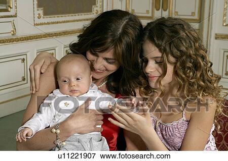Mother with daughter (9-11) and baby (3-6 months) View Large Photo Image Stock Photo - Mother with daughter (9-11) and baby (3-6 months). Fotosearch
