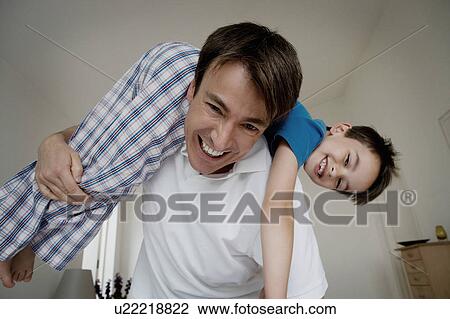 Portrait of a father and son playing. View Large Photo Image Stock Image - Portrait of a father and son playing.. Fotosearch