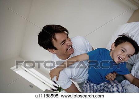 Stock Photography - Portrait of a father and son playing.. Fotosearch