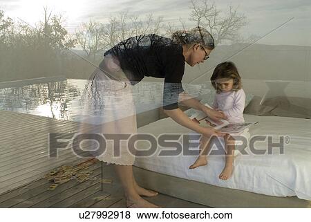 View through window of mother and daughter (2-4) reading book. View Large Photo Image Stock Photo - View through window of mother and daughter (2-4) reading book.. Fotosearch