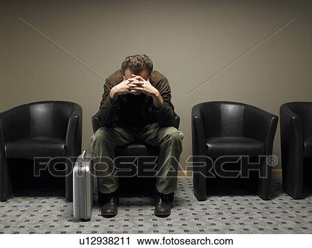 Anxious businessman in waiting room, head in hands. Brussels, Belgium. View Large Photo Image Stock Image - Anxious businessman in waiting room, head in hands. Brussels, Belgium.. Fotosearch