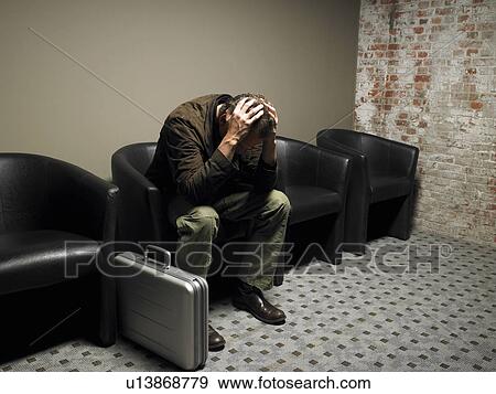 Anxious businessman in waiting room, head in hands. Brussels, Belgium. View Large Photo Image Stock Photo - Anxious businessman in waiting room, head in hands. Brussels, Belgium.. Fotosearch