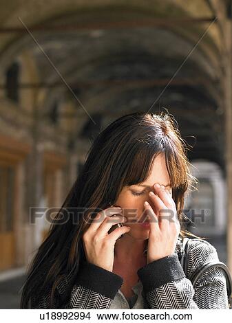 Picture - Crying woman talking on mobile phone. Venice, Italy.. Fotosearch