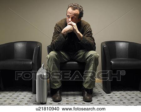 Mature businessman sitting in waiting room, resting chin on hands View Large Photo Image Stock Image - Mature businessman sitting in waiting room, resting chin on hands. Fotosearch