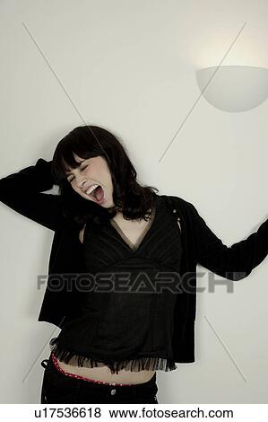 Stock Photo - Portrait of a woman yawning. Fotosearch