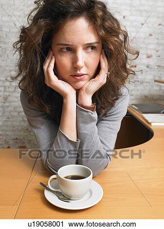 Serious woman at desk with coffee cup., Brussels, Belgium. View Large Photo Image Stock Image - Serious woman at desk with coffee cup., Brussels, Belgium.. Fotosearch