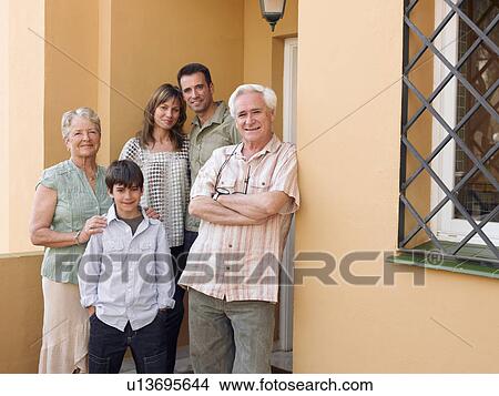 Multi-generational family standing on front porch, smiling, portrait View Large Photo Image Picture - Multi-generational family standing on front porch, smiling, portrait. Fotosearch