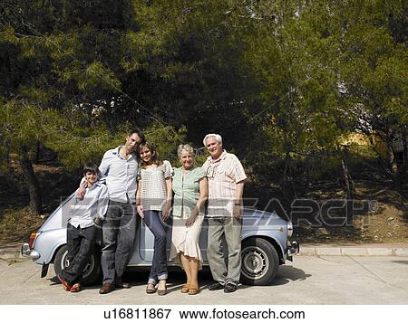 Multi-generational family standing beside car, smiling, portrait View Large Photo Image Stock Photo - Multi-generational family standing beside car, smiling, portrait. Fotosearch
