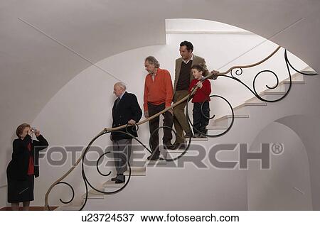 Stock Photo - Multigenerational family on staircase posing for photograph. Fotosearch