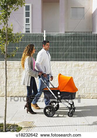 Couple walking with pram on pavement, Alicante, Spain, View Large Photo Image Stock Image - Couple walking with pram on pavement, Alicante, Spain,. Fotosearch