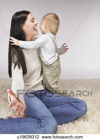 Stock Image - Daughter and mother playing.. Fotosearch