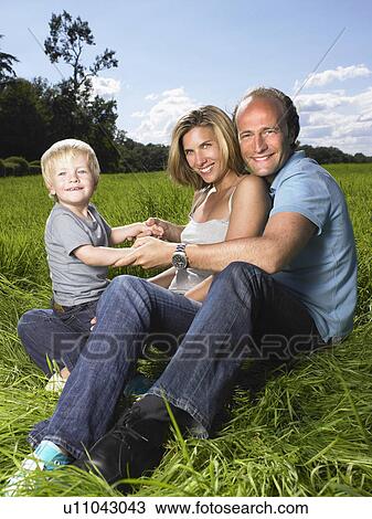 Stock Image - Family enjoying a good time in a field.. Fotosearch