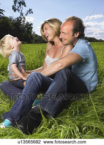 Stock Image - Family enjoying a good time in a field.. Fotosearch