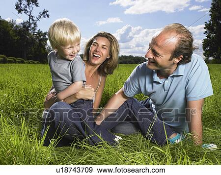 Stock Photo - Family enjoying a good time in a field.. Fotosearch