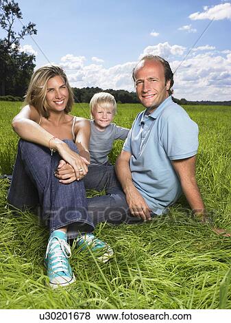 Stock Photo - Family enjoying a good time in a field.. Fotosearch