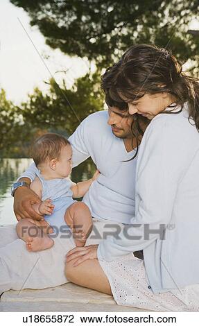Family s/baby outside embracing and smiling. View Large Photo Image Stock Image - Family s/baby outside embracing and smiling.. Fotosearch