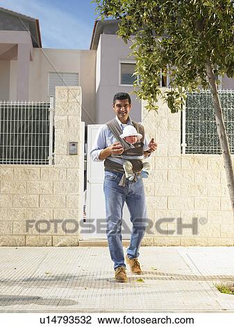 Father looking at camera with 5 month old baby in sling, urban location, Alicante, Spain, View Large Photo Image Stock Image - Father looking at camera with 5 month old baby in sling, urban location, Alicante, Spain,. Fotosearch